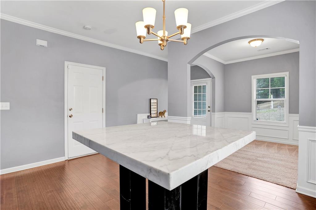 7789 Village Pass Fairburn, GA 30213 - Photo 9 of 35 a dining hall with stainless steel appliances granite countertop a kitchen island a stove and a sink