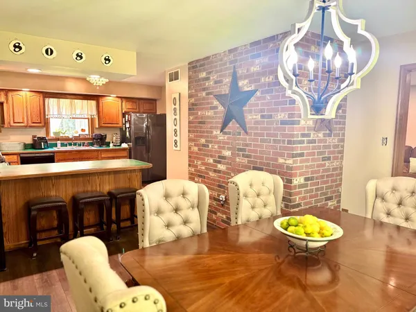 a living room with furniture a chandelier and a fireplace