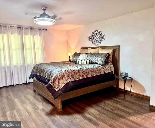 a bedroom with a bed chandelier and window