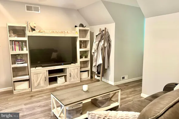 a living room with a flat screen tv and a fireplace