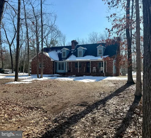 a view of a house with a yard covered with snow