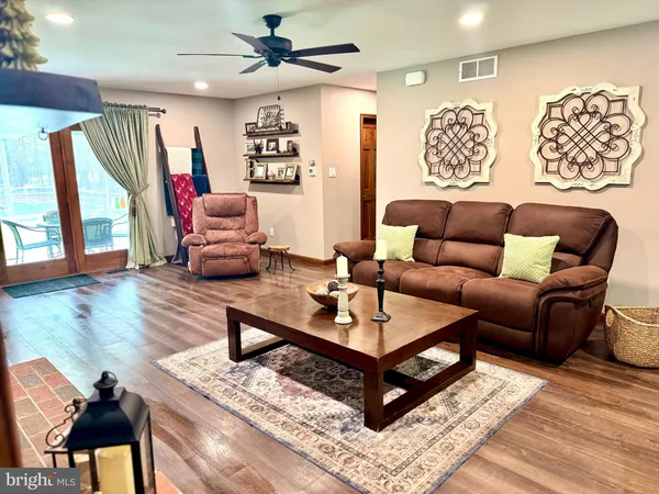 a living room with furniture and a wooden floor