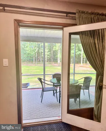 a view of a room with a dining table and chairs