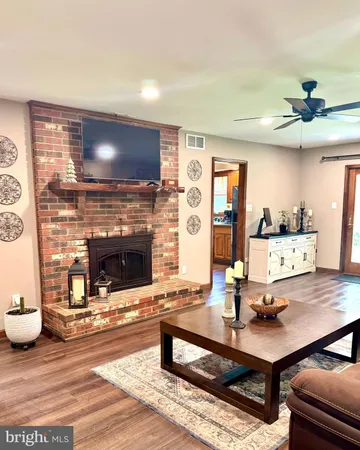 a living room with furniture and a fireplace