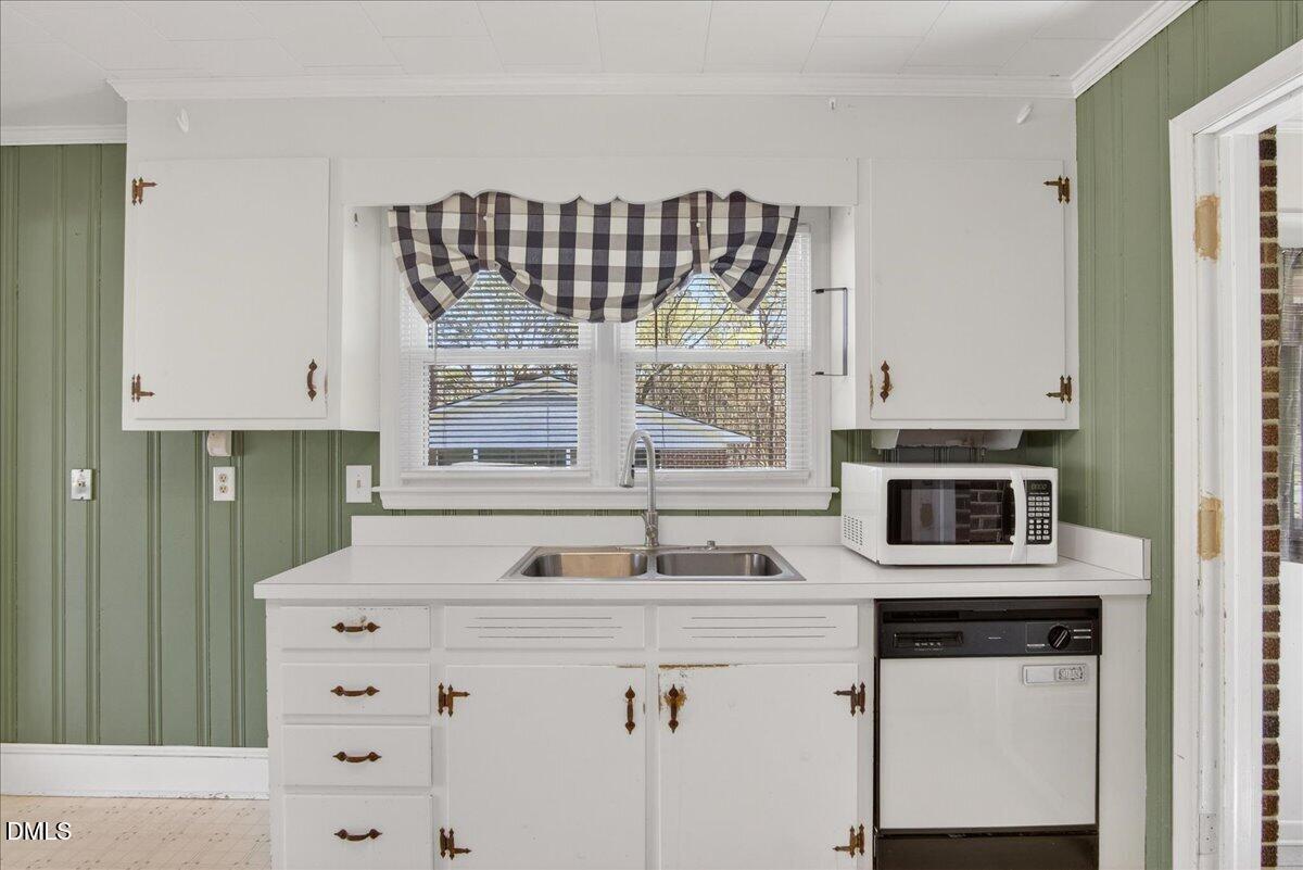 2118 Nutbush Road Henderson, NC 27537 - Photo 8 of 61 a kitchen with a sink stove and microwave