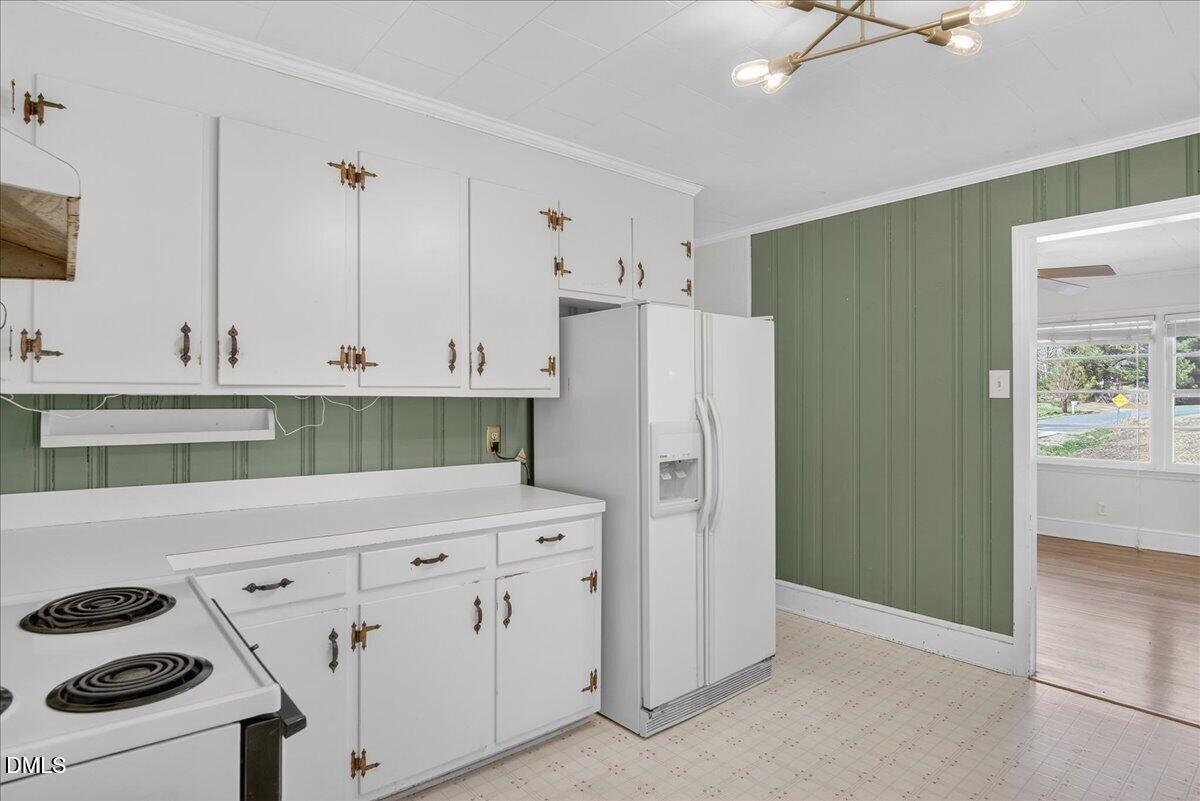 2118 Nutbush Road Henderson, NC 27537 - Photo 9 of 61 a kitchen with stainless steel appliances white cabinets and a refrigerator