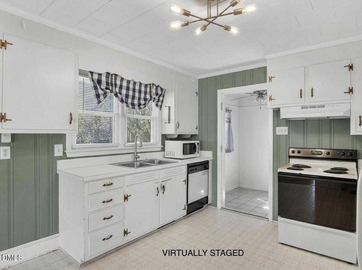 2118 Nutbush Road Henderson, NC 27537 - Photo 10 of 61 a kitchen with a stove a sink and a refrigerator