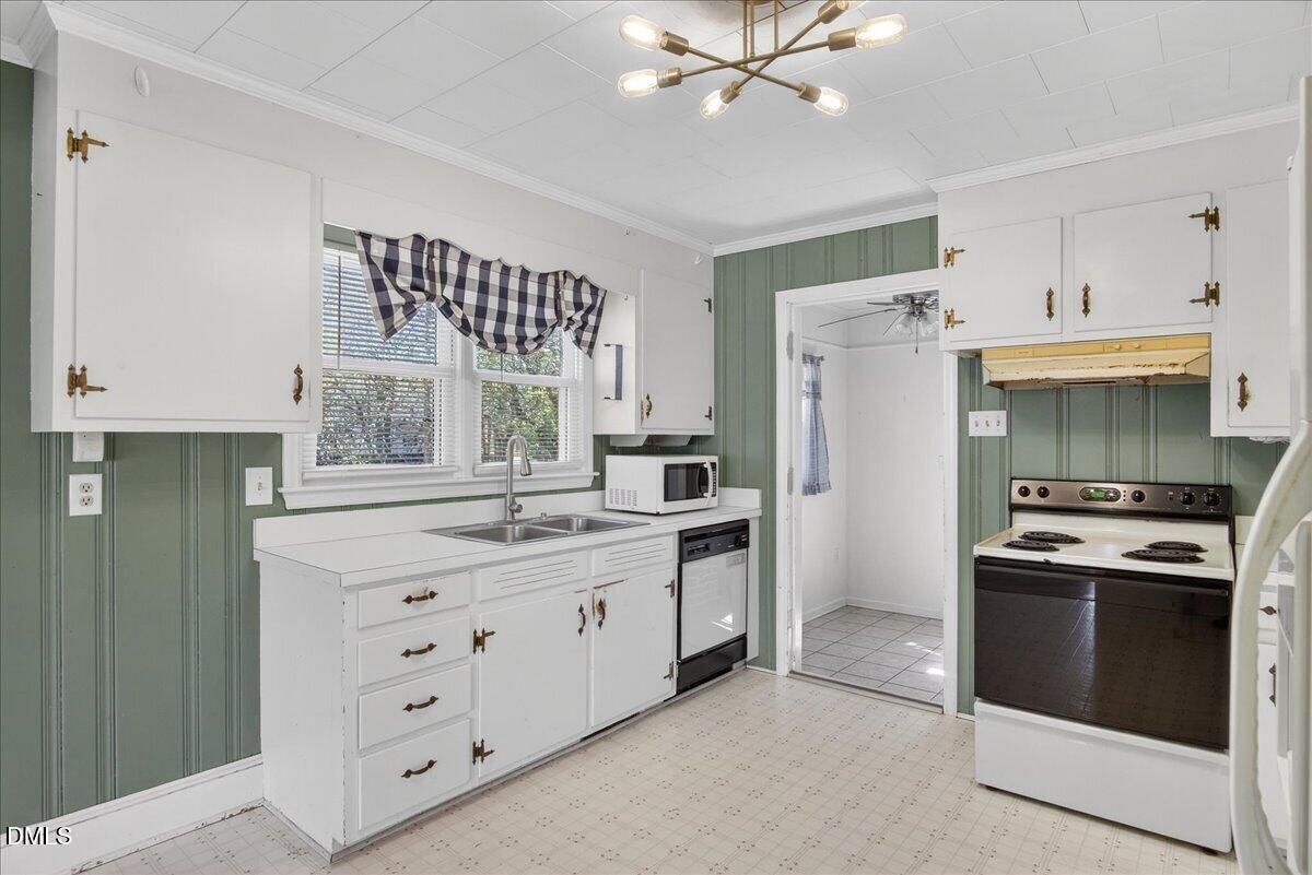 2118 Nutbush Road Henderson, NC 27537 - Photo 11 of 61 a kitchen with a stove a sink and a refrigerator