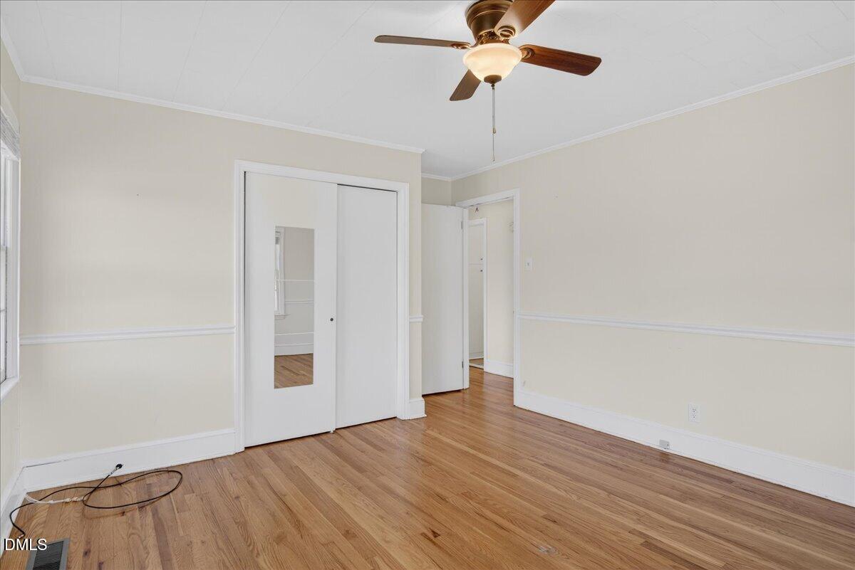 2118 Nutbush Road Henderson, NC 27537 - Photo 18 of 61 a view of empty room with wooden floor and fan