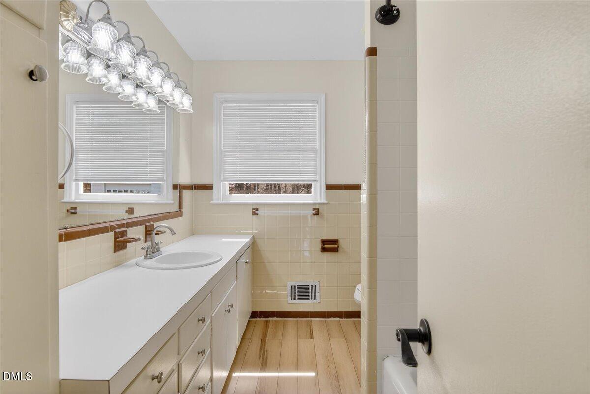 2118 Nutbush Road Henderson, NC 27537 - Photo 20 of 61 a bathroom with a sink a mirror and a shower