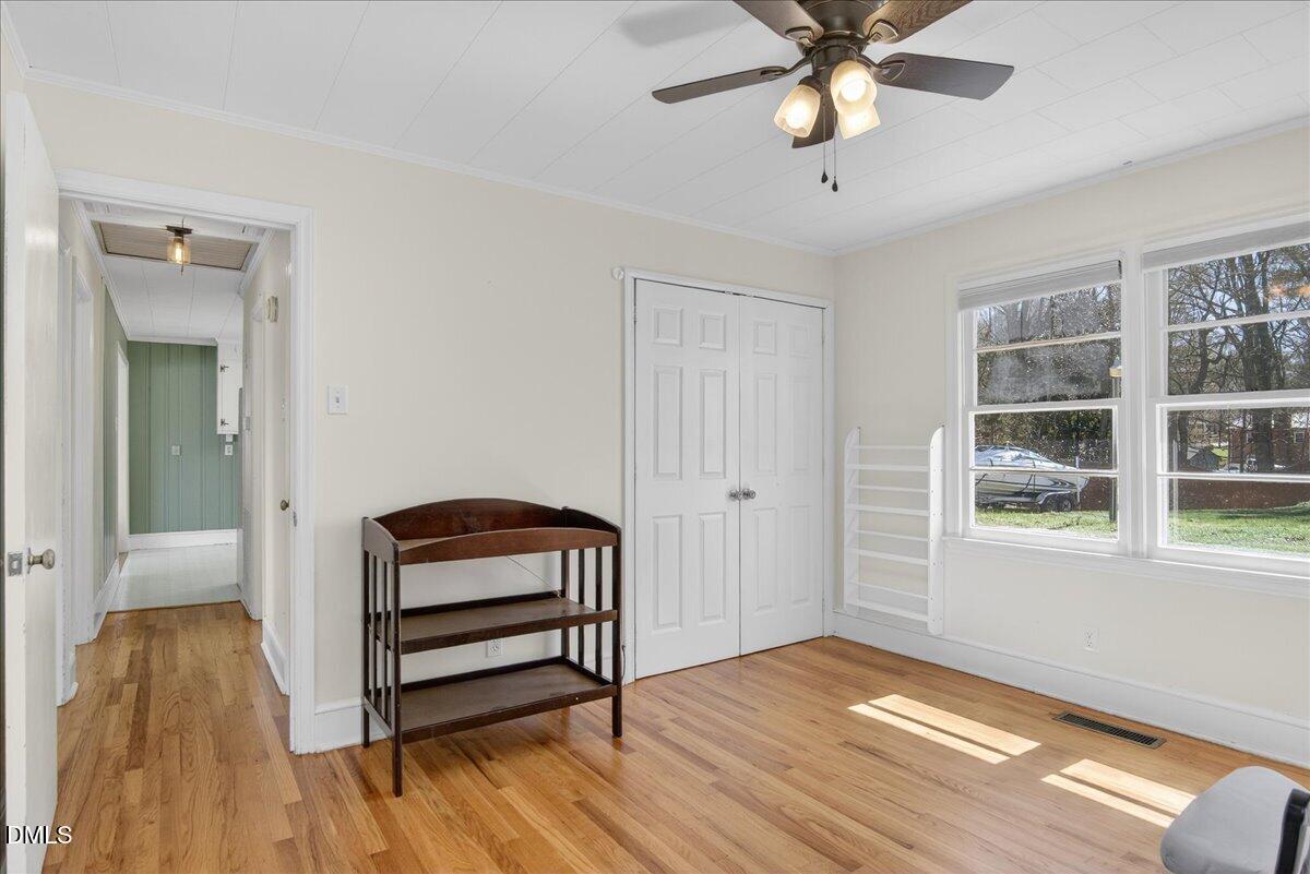 2118 Nutbush Road Henderson, NC 27537 - Photo 22 of 61 a view of an empty room with window and wooden floor