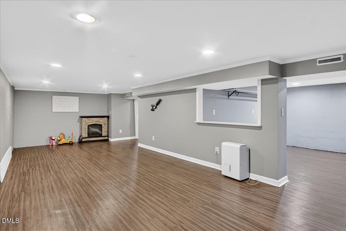 2118 Nutbush Road Henderson, NC 27537 - Photo 30 of 61 a view of empty room with wooden floor and fireplace
