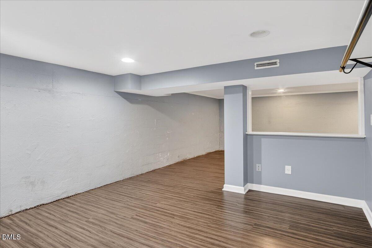 2118 Nutbush Road Henderson, NC 27537 - Photo 37 of 61 a view of an empty room with wooden floor