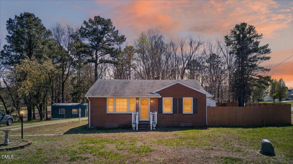 2118 Nutbush Road Henderson, NC 27537 - Photo 41 of 61 a front view of a house with a yard and garage