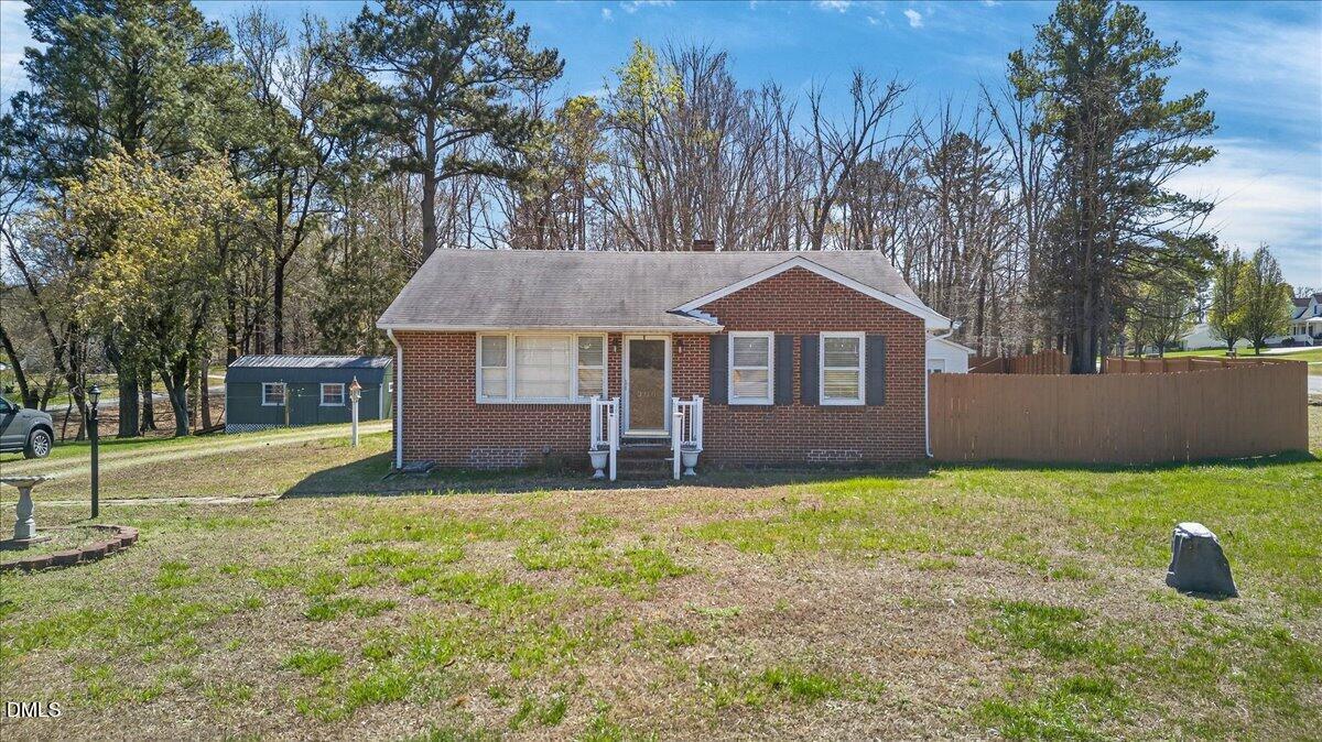 2118 Nutbush Road Henderson, NC 27537 - Photo 42 of 61 a brick house with garden in front of it