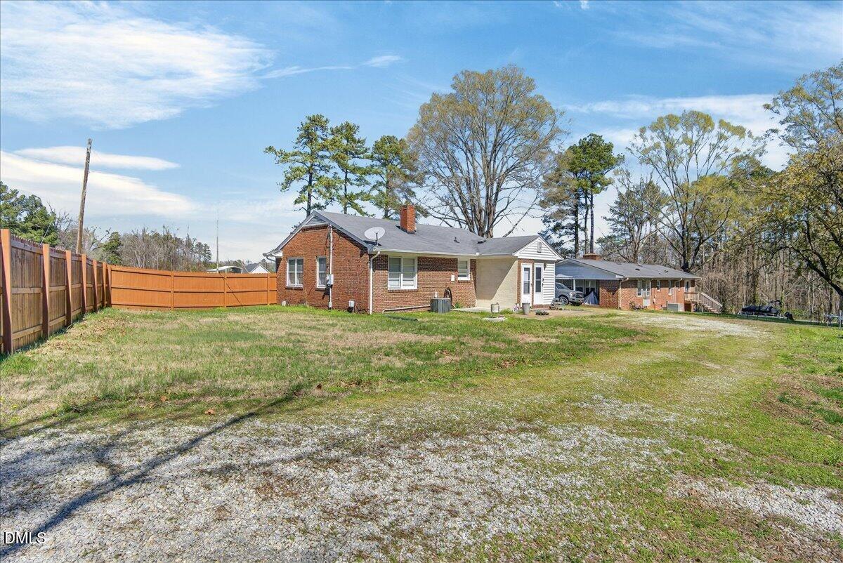 2118 Nutbush Road Henderson, NC 27537 - Photo 45 of 61 a front view of a house with a garden