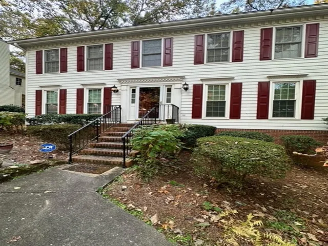 a front view of a house with garden and porch