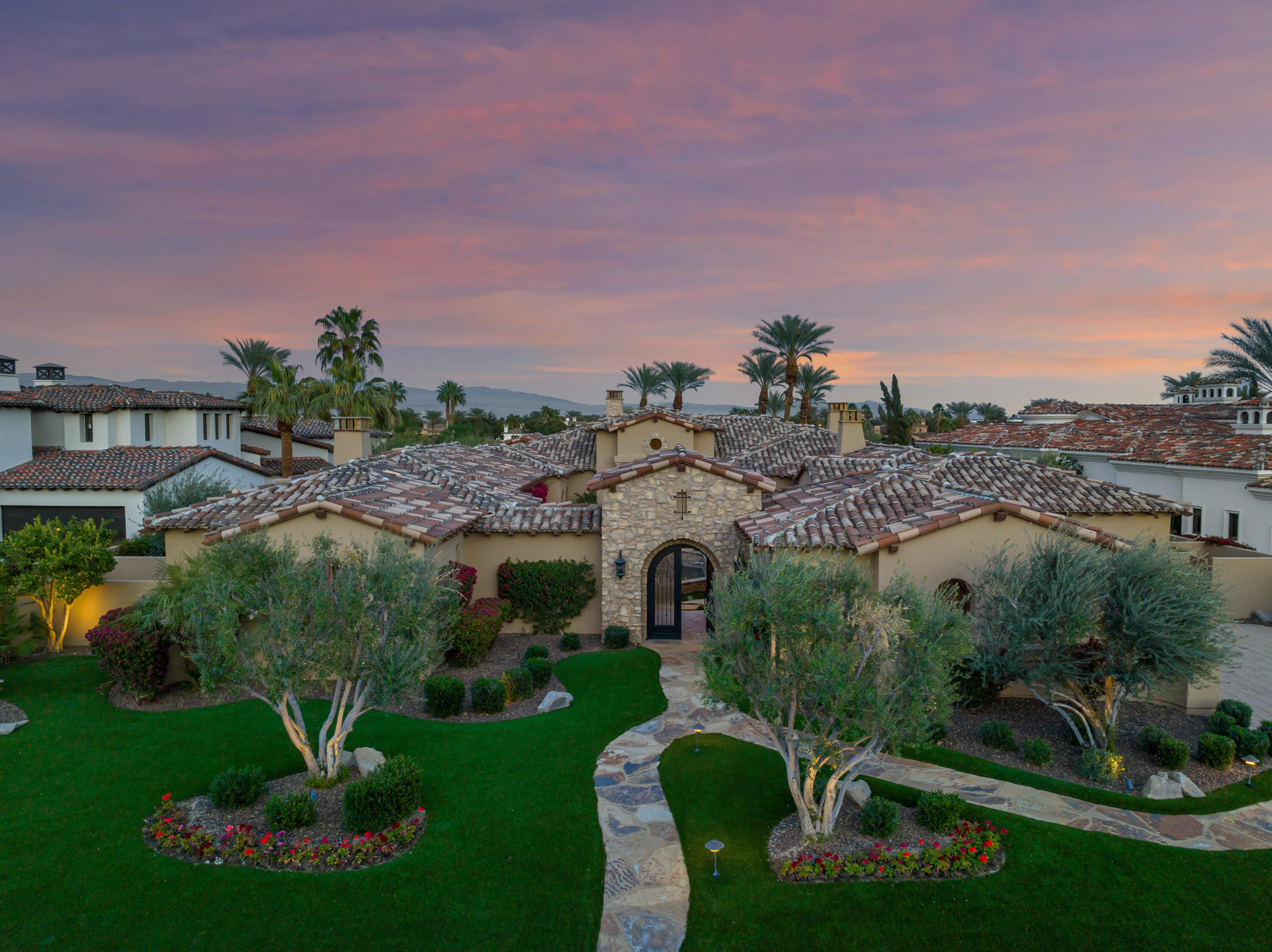 a view of a garden with a building in the background
