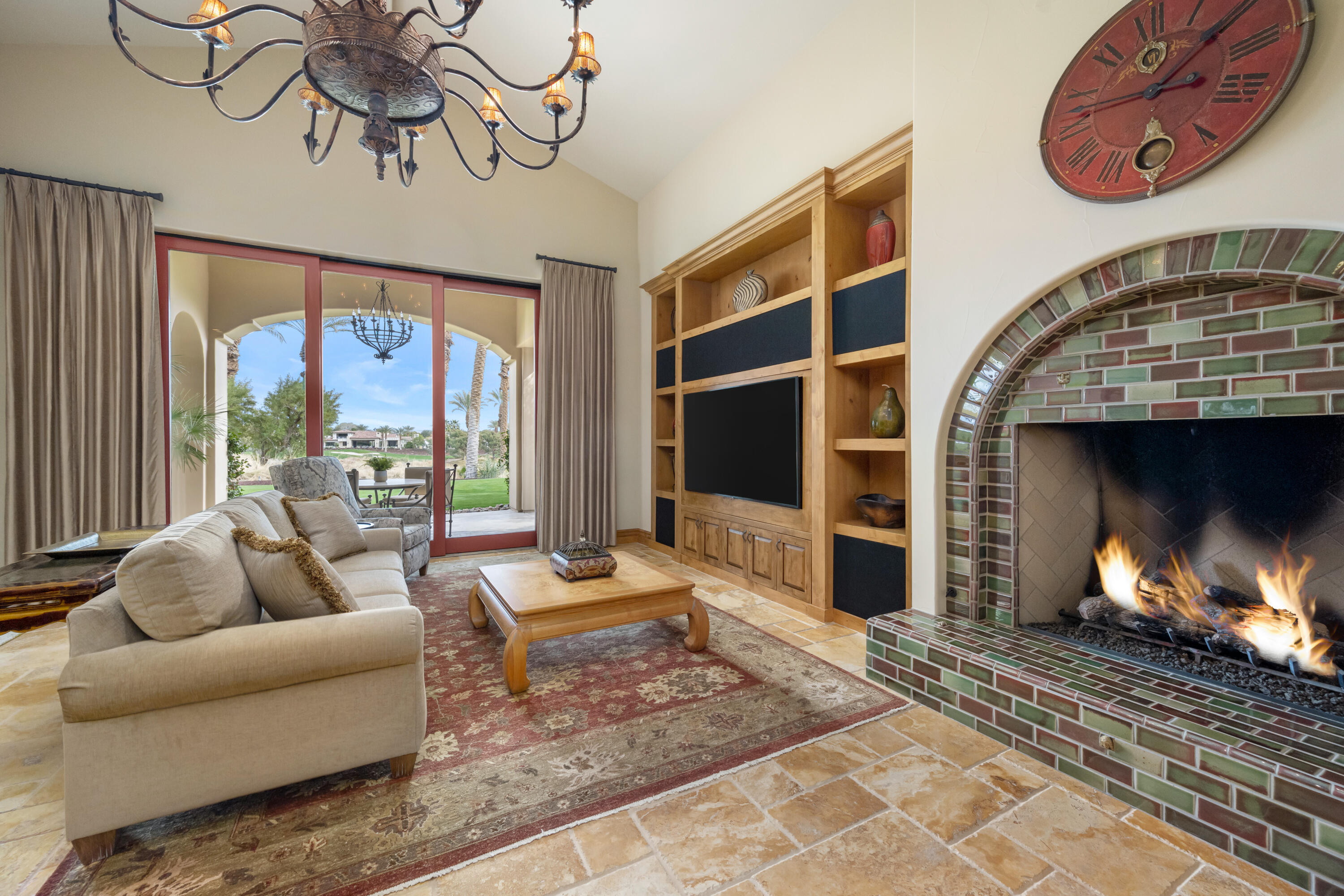 52844 Via Dona La Quinta, CA 92253 - Photo 14 of 46 a living room with furniture a fireplace and a floor to ceiling window