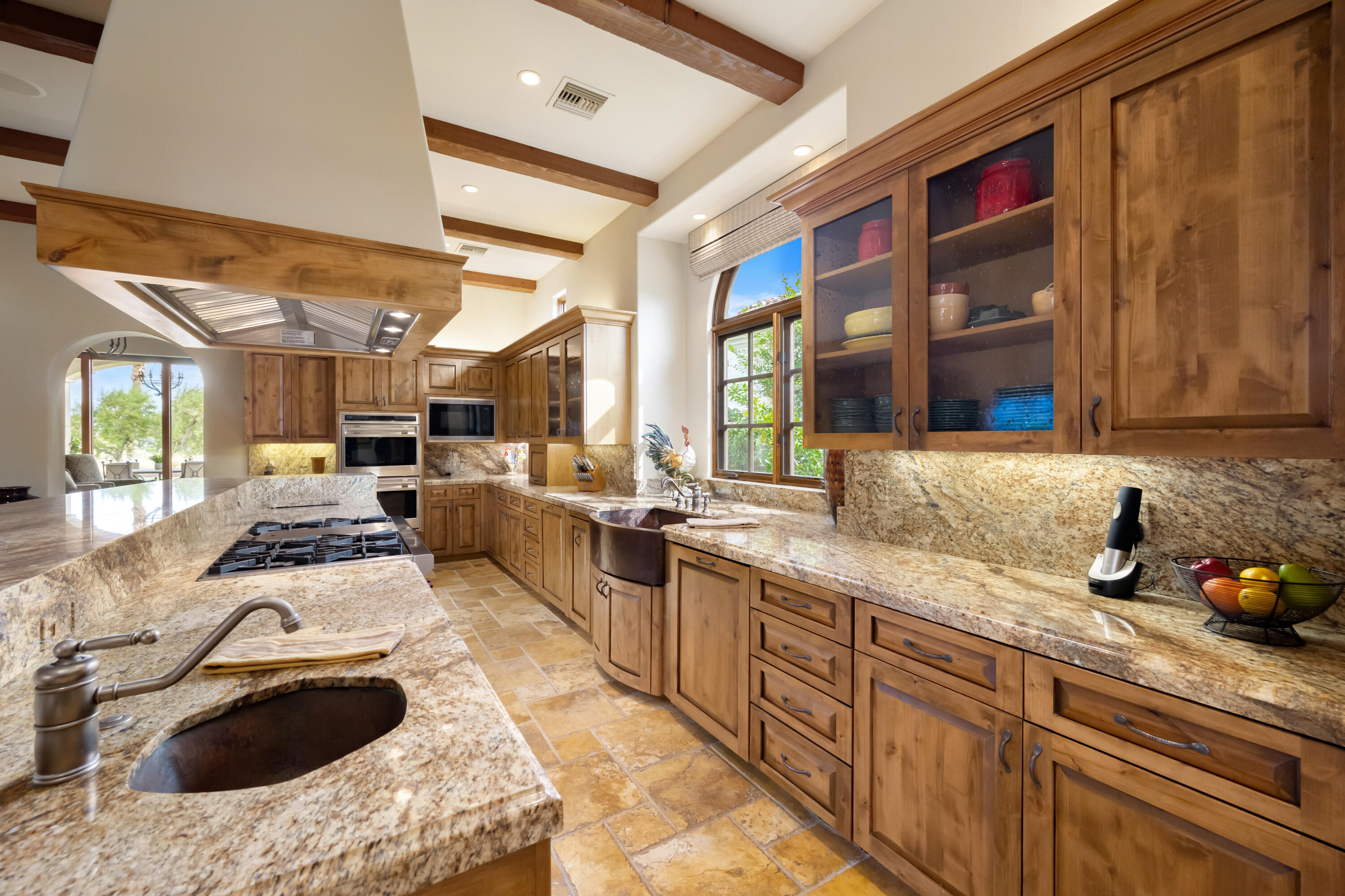 52844 Via Dona La Quinta, CA 92253 - Photo 16 of 46 a kitchen with granite countertop a sink stainless steel appliances and cabinets