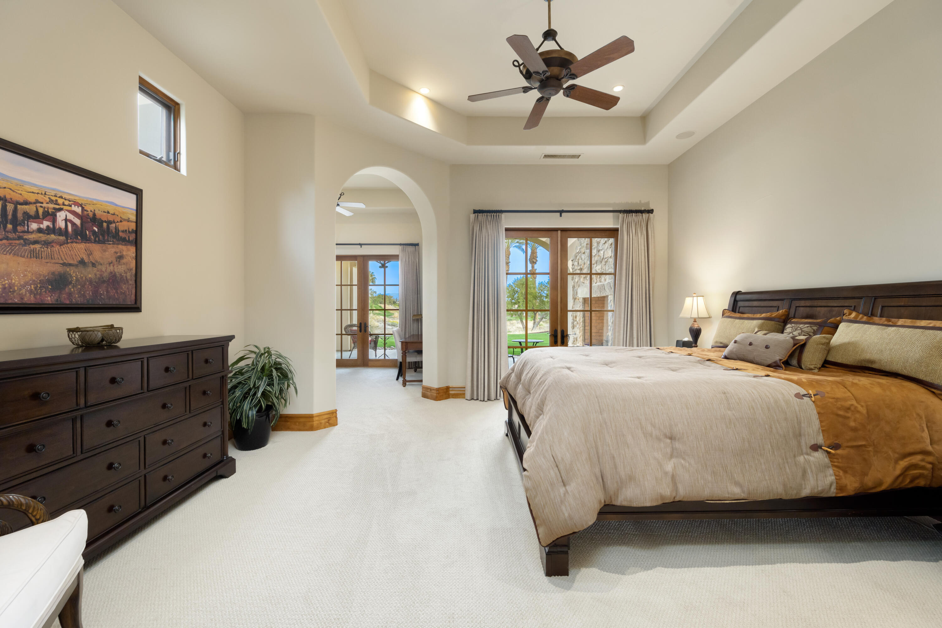 52844 Via Dona La Quinta, CA 92253 - Photo 25 of 46 a spacious bedroom with a bed a flat screen tv and a dresser