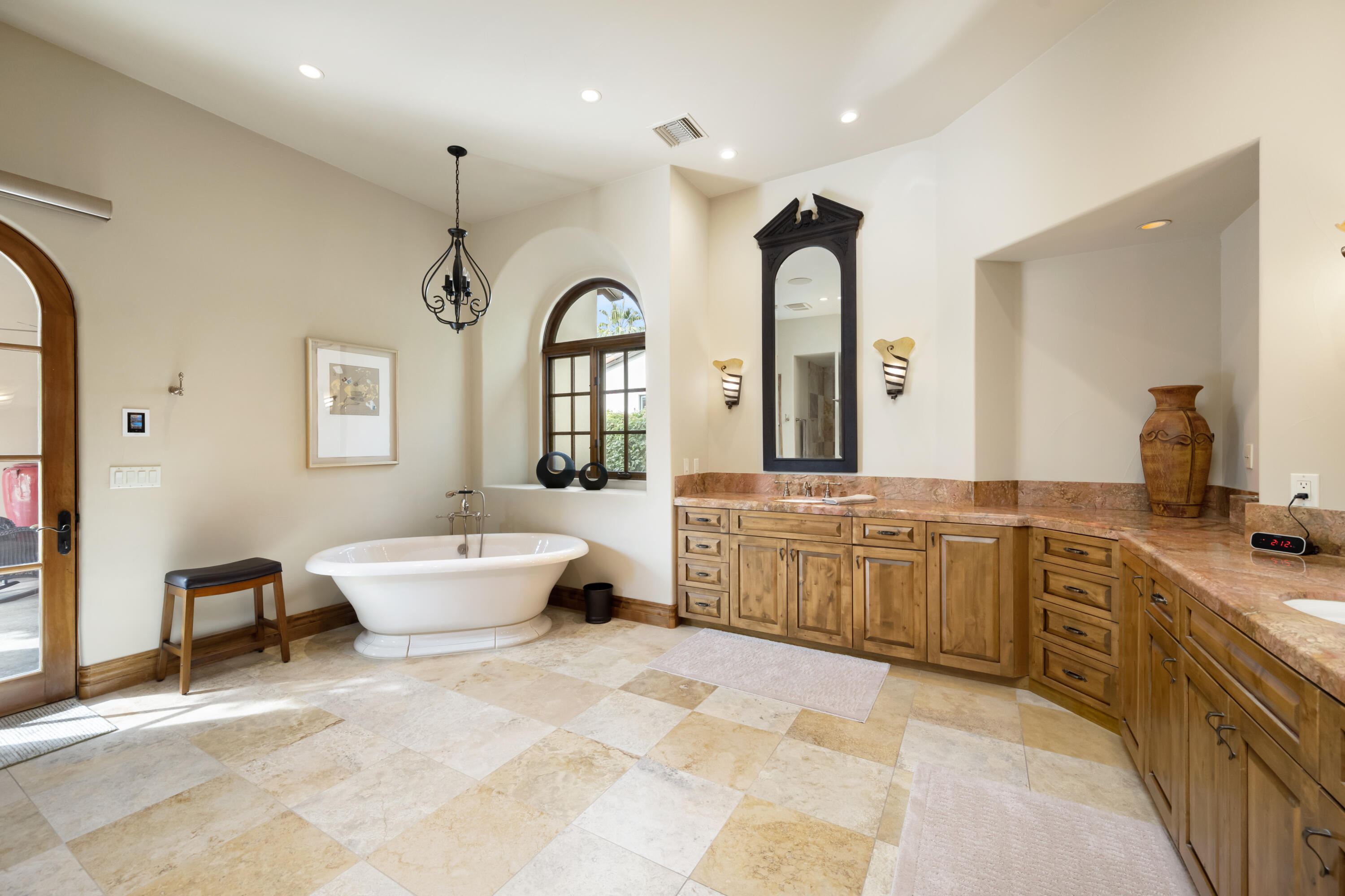 52844 Via Dona La Quinta, CA 92253 - Photo 28 of 46 a large spacious bathroom with a granite countertop tub a double vanity sink and a large mirror