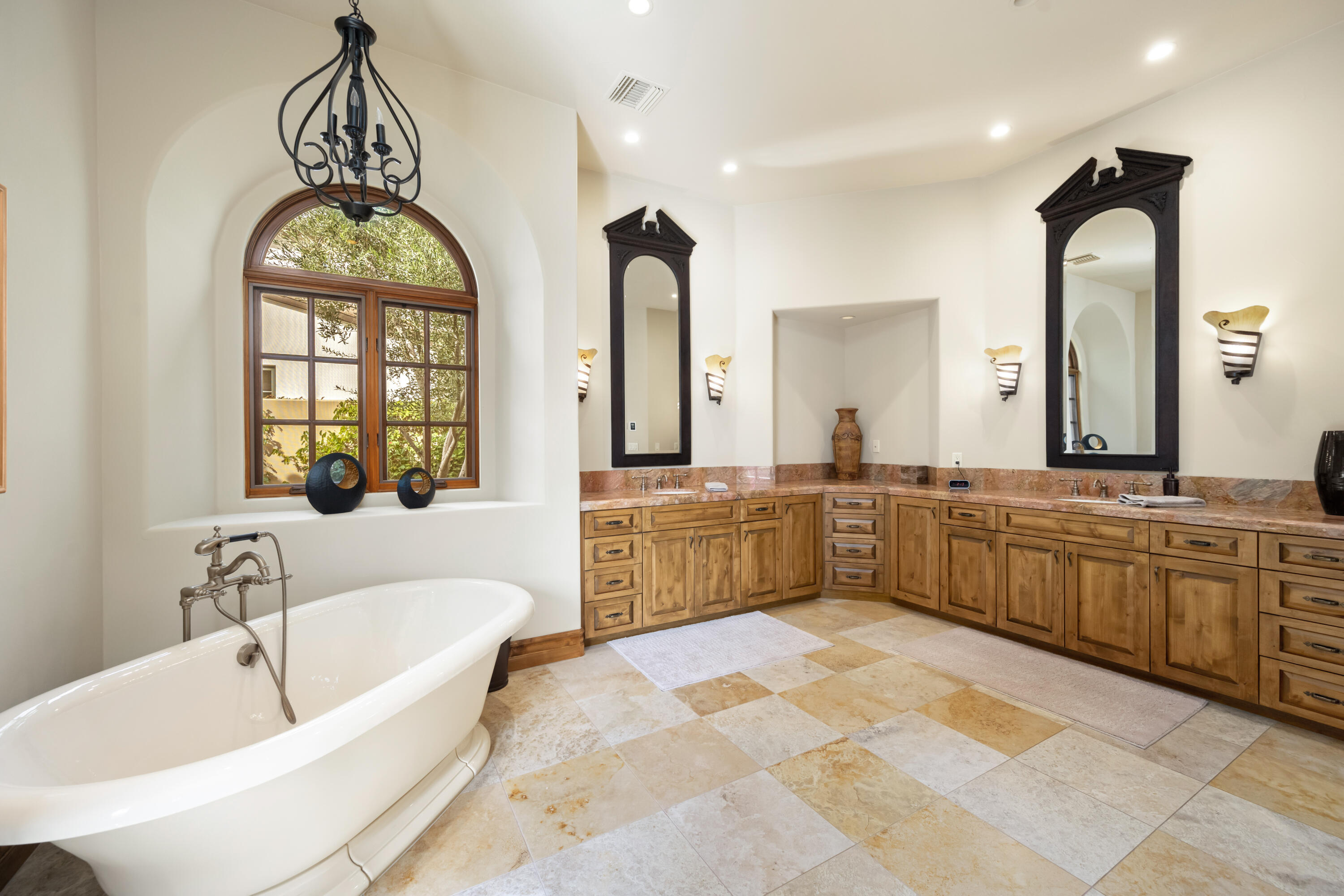 52844 Via Dona La Quinta, CA 92253 - Photo 29 of 46 a large spacious bathroom with a granite countertop tub a double vanity sink and a large mirror
