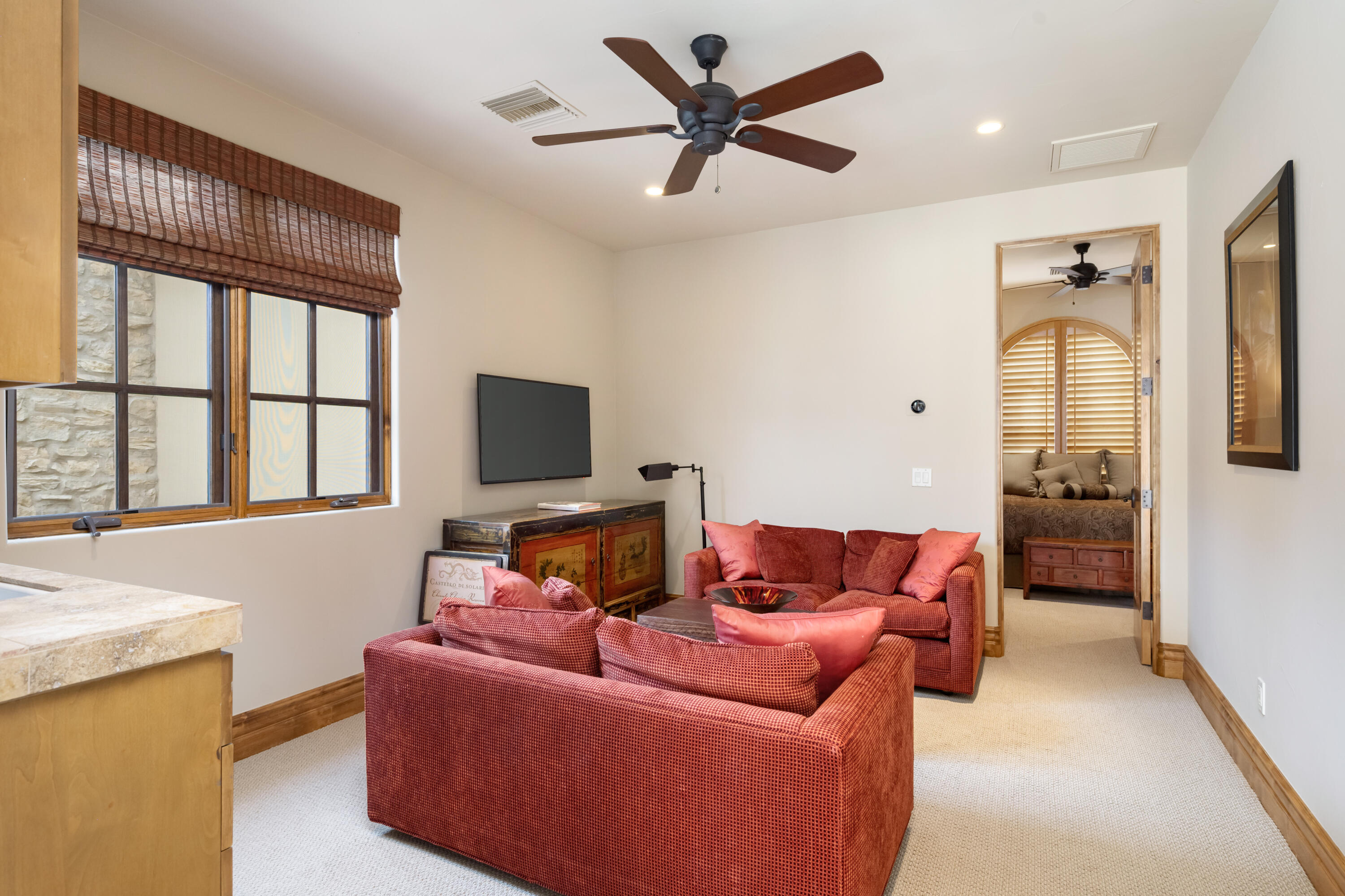 52844 Via Dona La Quinta, CA 92253 - Photo 33 of 46 a living room with furniture a ceiling fan and a large window