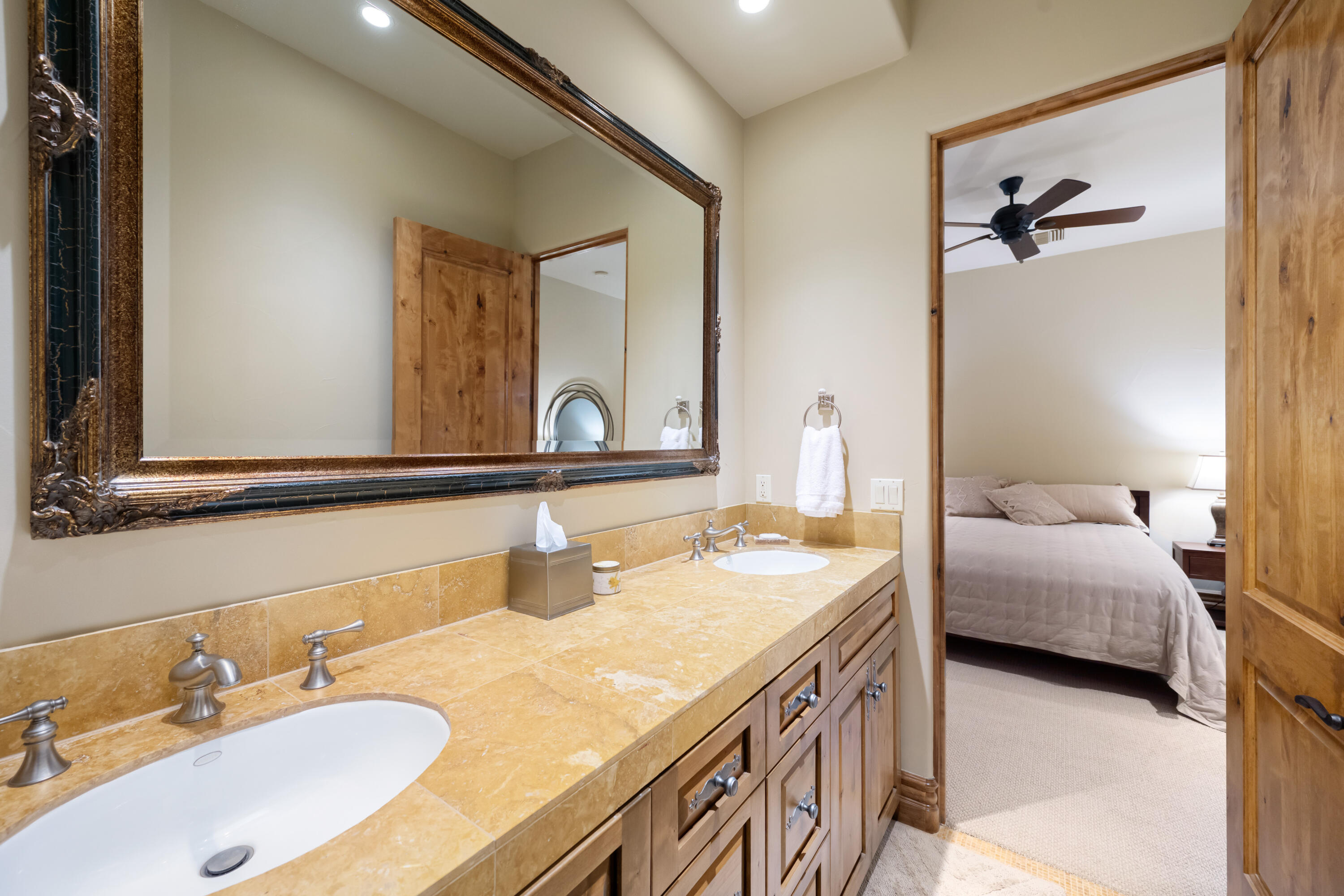 52844 Via Dona La Quinta, CA 92253 - Photo 38 of 46 a en suite bathroom with a double vanity sink and a mirror