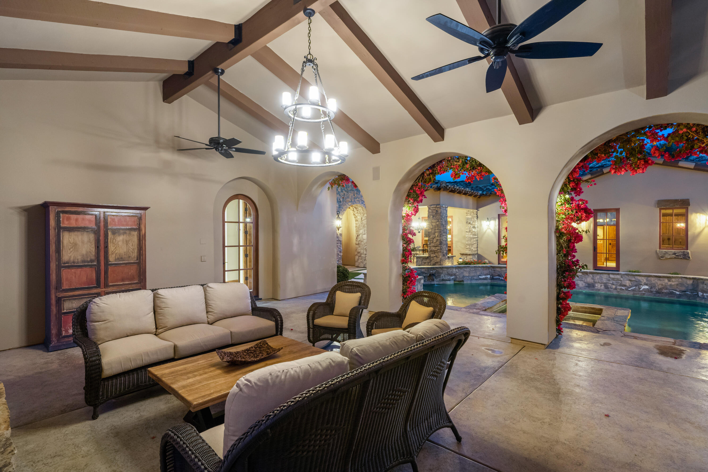 52844 Via Dona La Quinta, CA 92253 - Photo 8 of 46 a living room with couches a dining table and chairs with chandelier