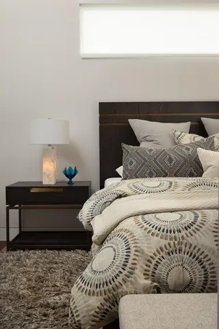 a bedroom with a bed and window