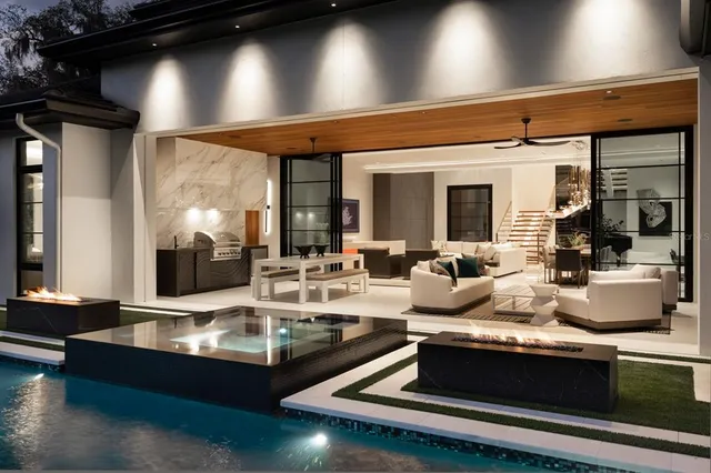 a living room with kitchen island granite countertop furniture and a fireplace