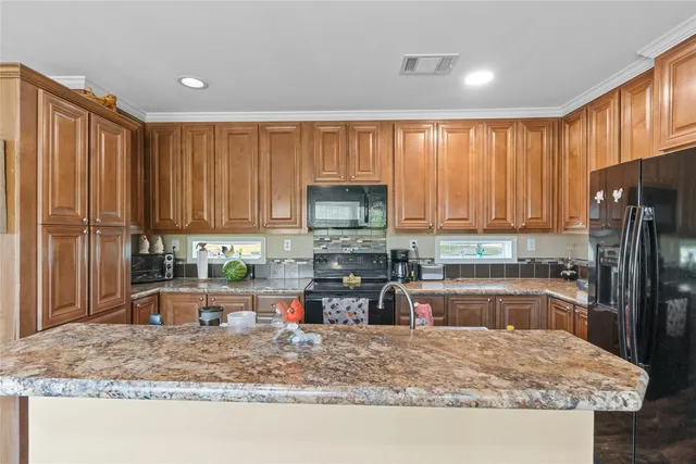 a kitchen with a sink stove and refrigerator