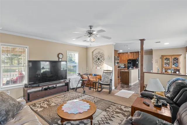 a kitchen with stainless steel appliances granite countertop a refrigerator a stove top oven a sink dishwasher and wooden cabinets with wooden floor