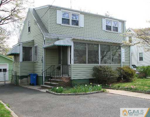 54 Coldevin Road Clark, NJ 07066 - Photo 1 of 8 a front view of a house with a garden and plants