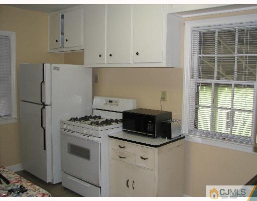 54 Coldevin Road Clark, NJ 07066 - Photo 3 of 8 a kitchen with appliances a stove and a window