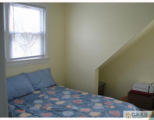 54 Coldevin Road Clark, NJ 07066 - Photo 6 of 8 a bedroom with a bed and a window