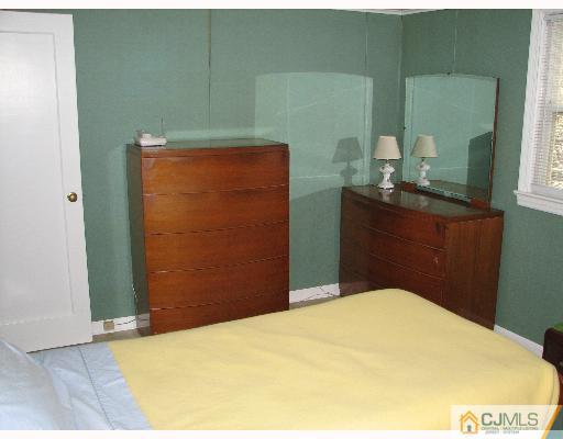 54 Coldevin Road Clark, NJ 07066 - Photo 7 of 8 a bedroom with a bed and dresser