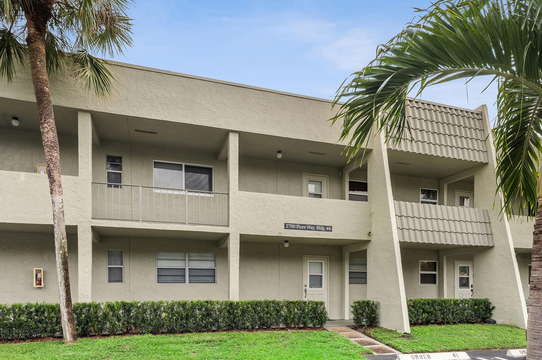 2700 Fiore Way, Unit 211 Delray Beach, FL 33445 - Photo 11 of 11 a front view of a house with a garden