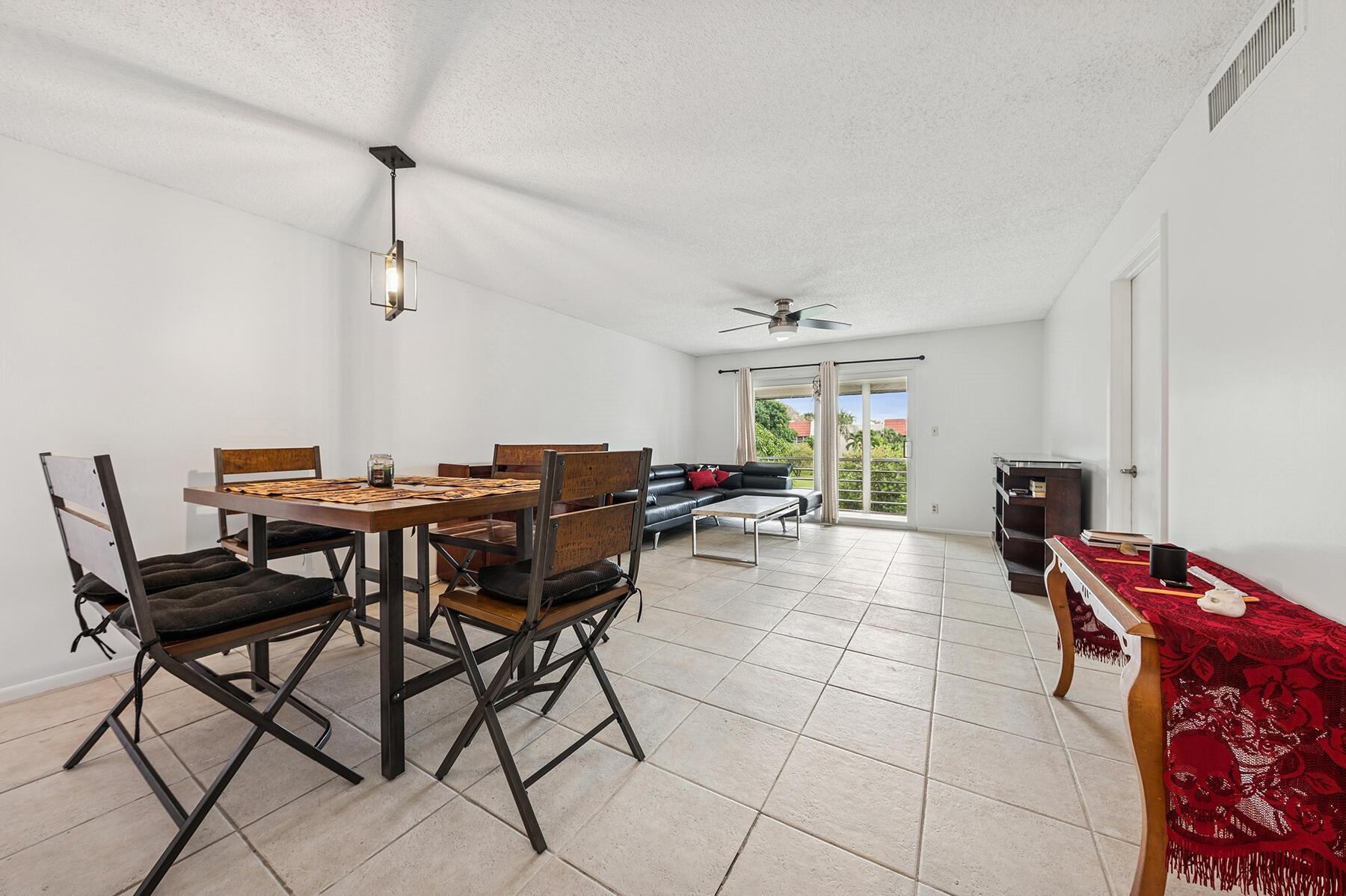 2700 Fiore Way, Unit 211 Delray Beach, FL 33445 - Photo 3 of 11 a view of a dining room with furniture and a rug