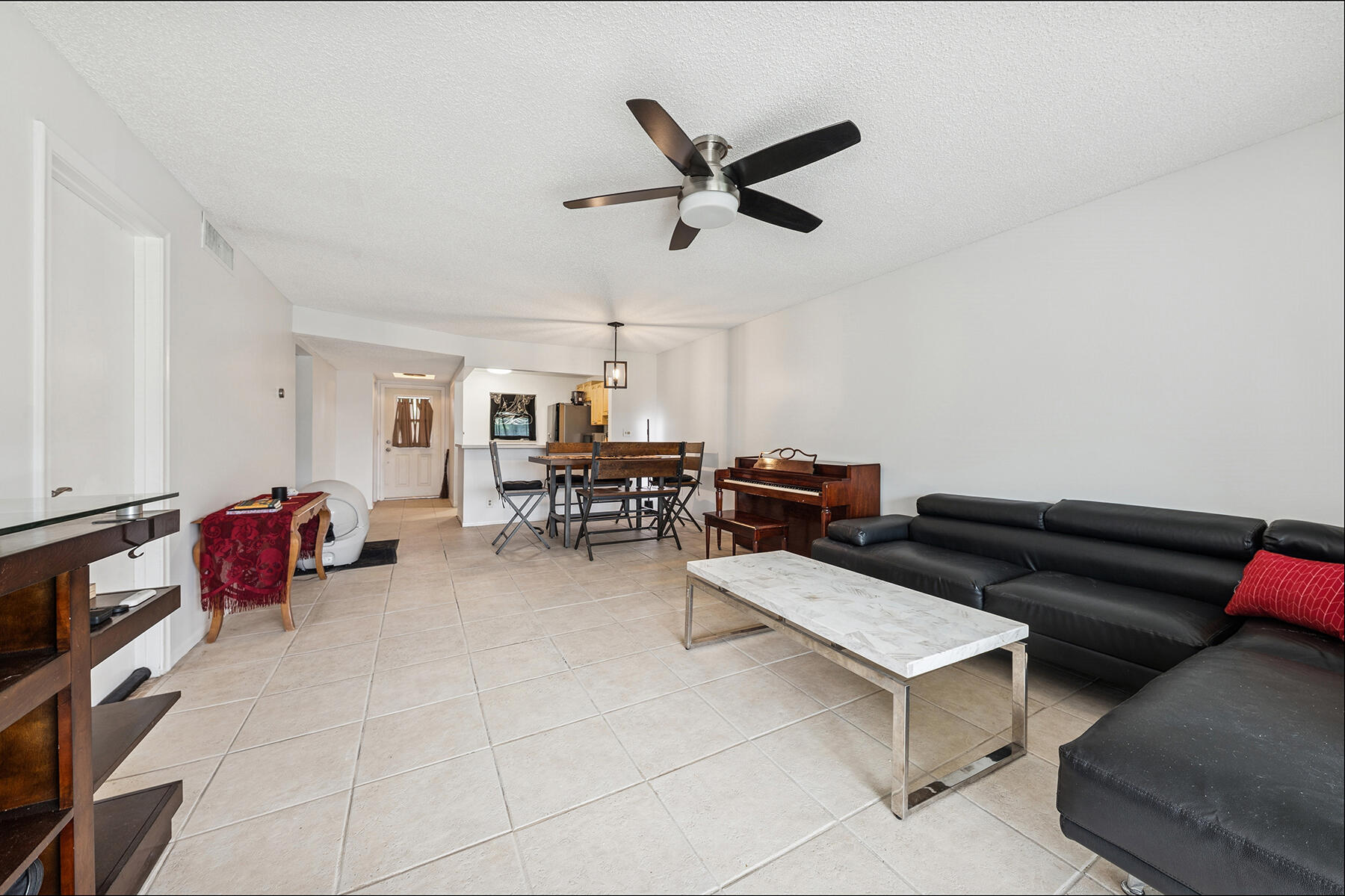 2700 Fiore Way, Unit 211 Delray Beach, FL 33445 - Photo 5 of 11 a living room with furniture and a window