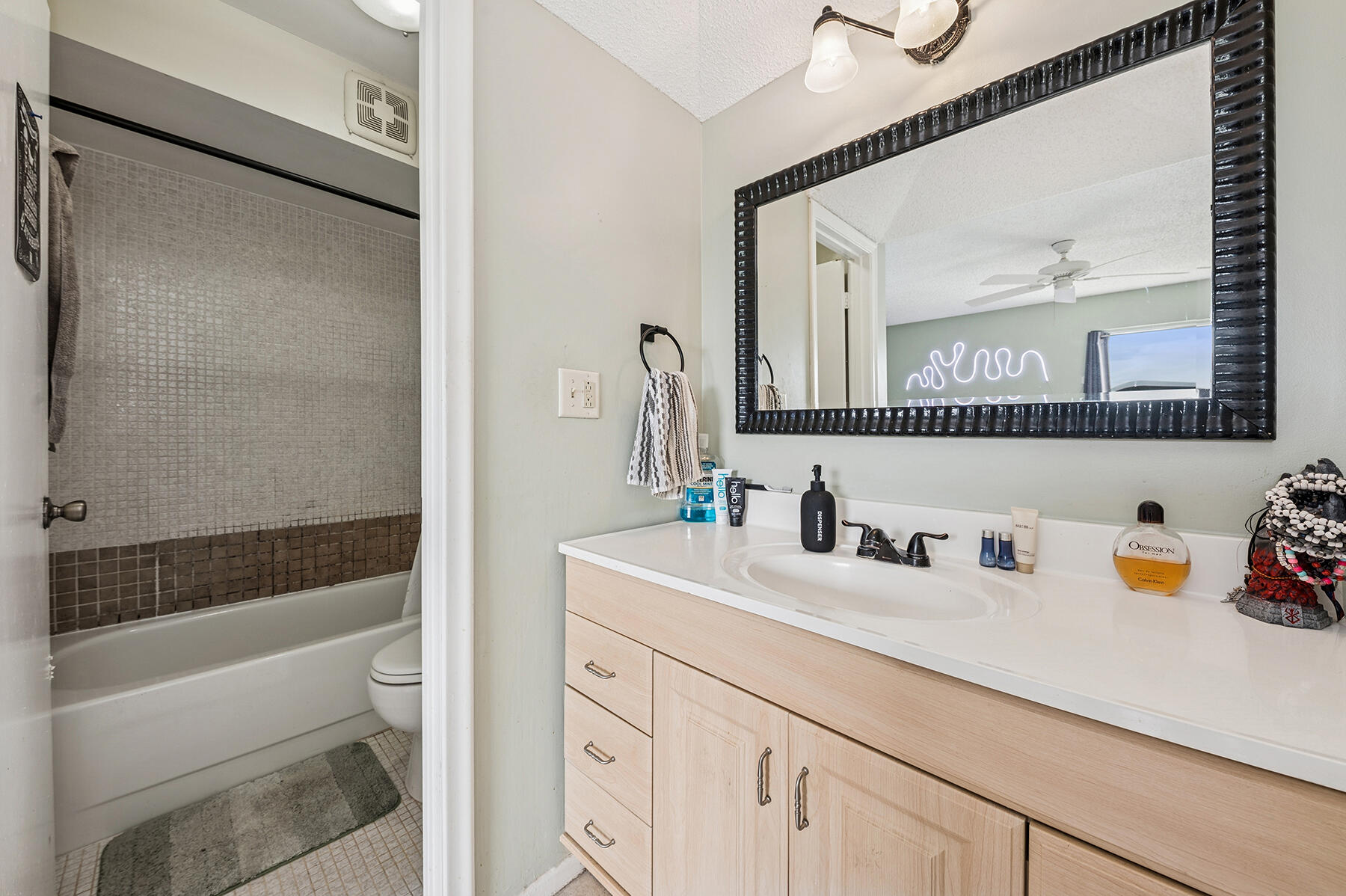 2700 Fiore Way, Unit 211 Delray Beach, FL 33445 - Photo 7 of 11 a bathroom with a sink a toilet and a bathtub