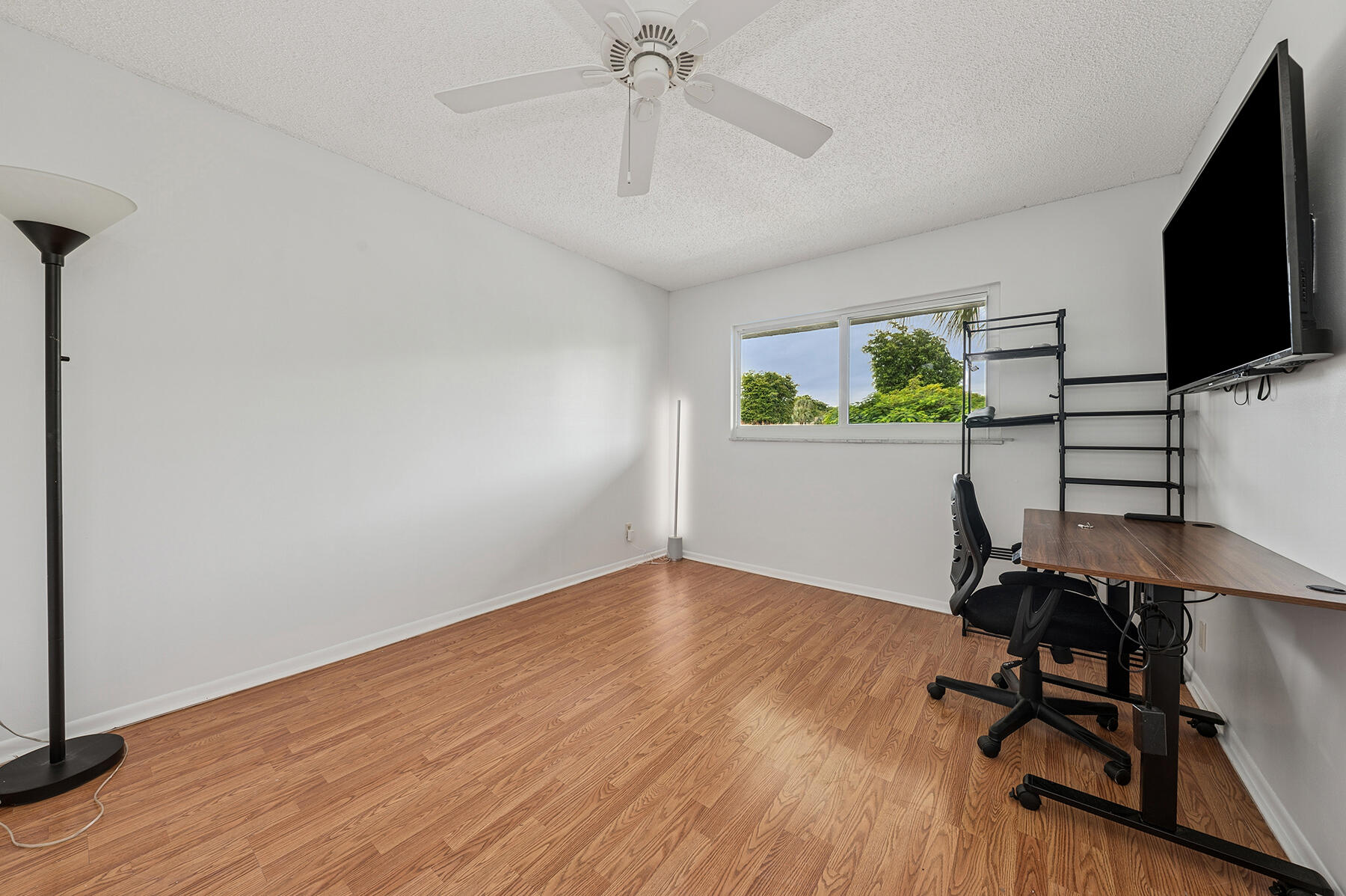 2700 Fiore Way, Unit 211 Delray Beach, FL 33445 - Photo 8 of 11 a workspace with furniture and wooden floor