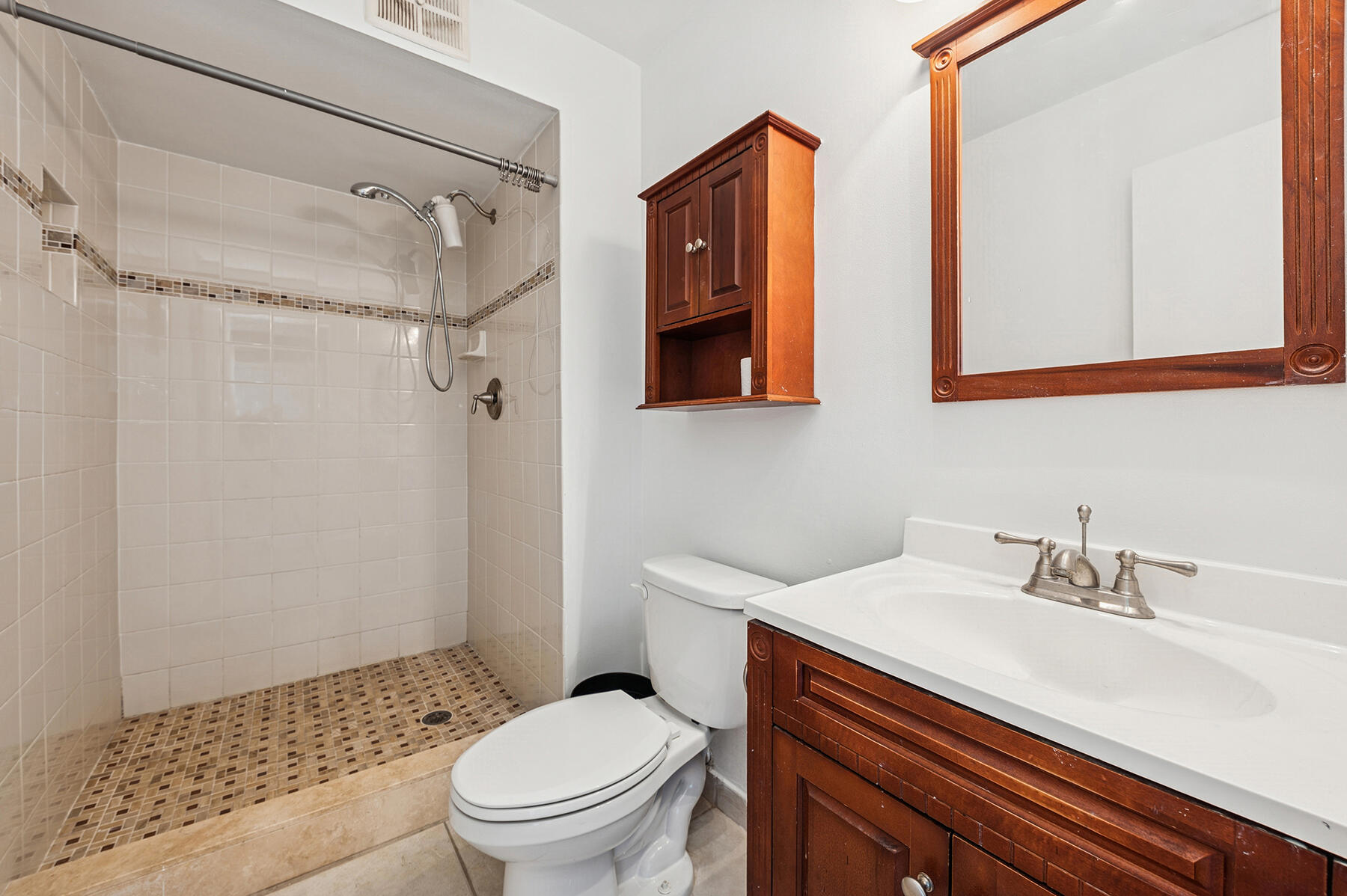 2700 Fiore Way, Unit 211 Delray Beach, FL 33445 - Photo 9 of 11 a bathroom with a sink toilet vanity and shower