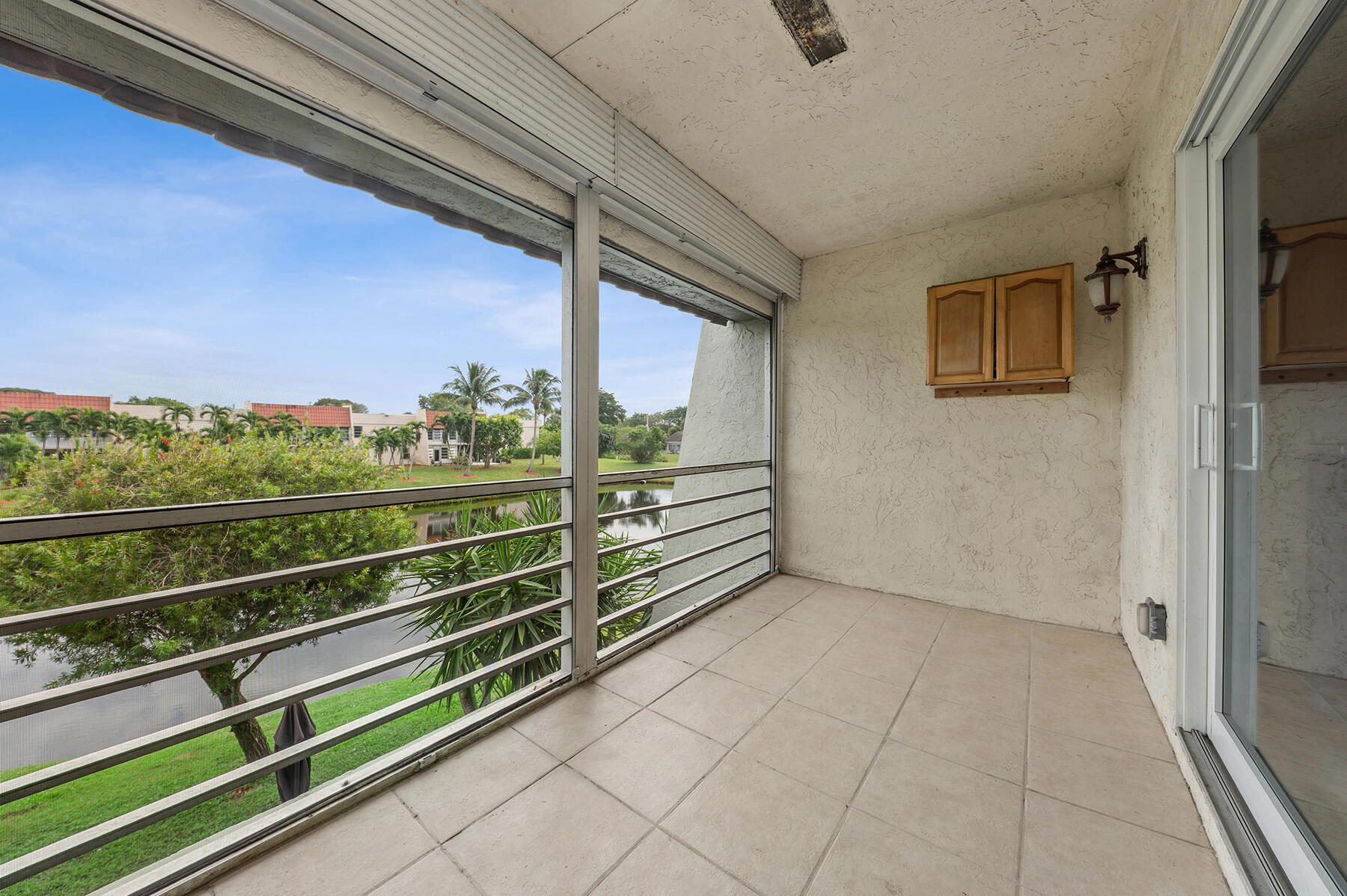 2700 Fiore Way, Unit 211 Delray Beach, FL 33445 - Photo 10 of 11 a view of a room with wooden floor and windows