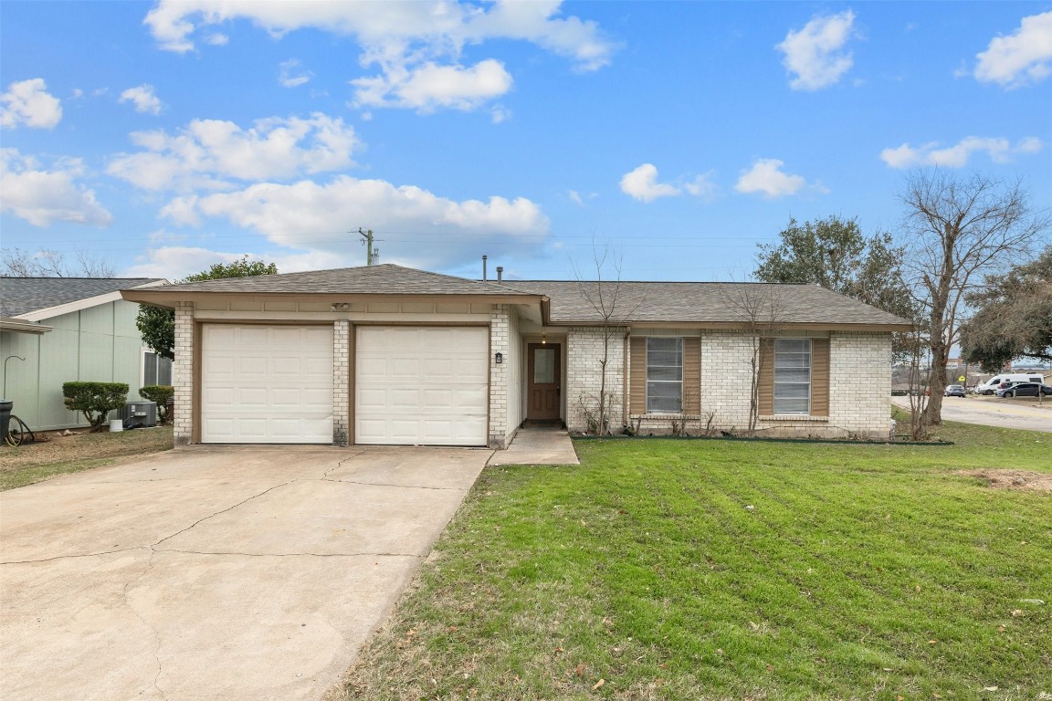a view of a house with a yard and garage