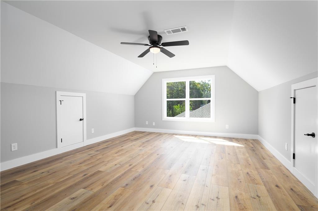111 Lee Road Phenix City, AL 36867 - Photo 18 of 23 Vaulted ceiling, wood-finish flooring, ceiling fan, white trim, and a window with exterior views
