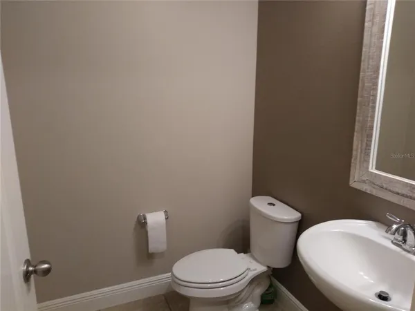 a white toilet sitting next to a bathroom sink