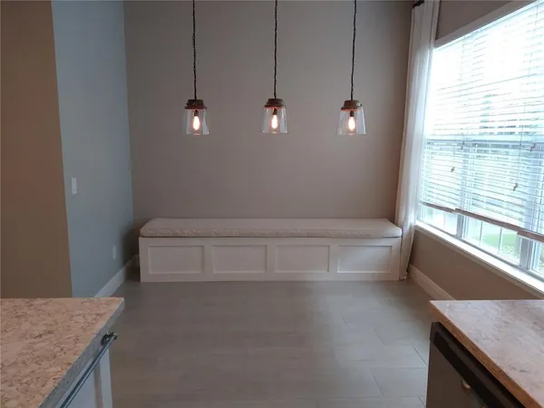 a bathroom with a granite countertop sink a toilet and bathtub