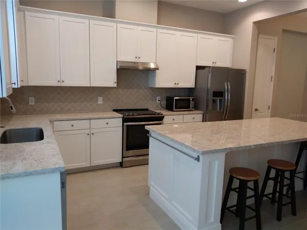 a kitchen with a sink a stove and refrigerator
